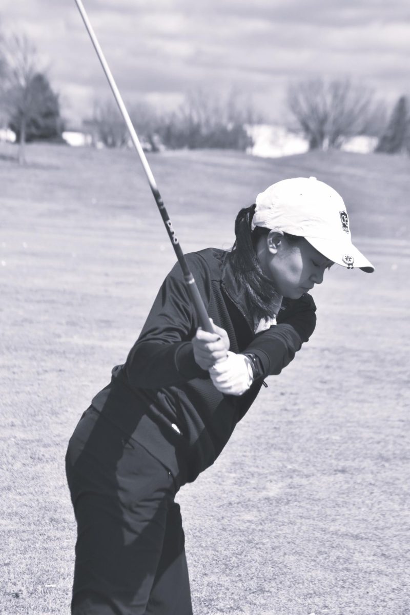 Sachi Santos winding up for a drive on the driving range.